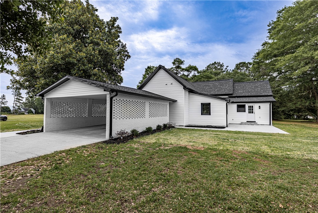 2817 Broadway Lake Road Anderson, SC 29621 - Photo 9 of 41 A well-maintained facade with a covered carport provides convenient outdoor parking.