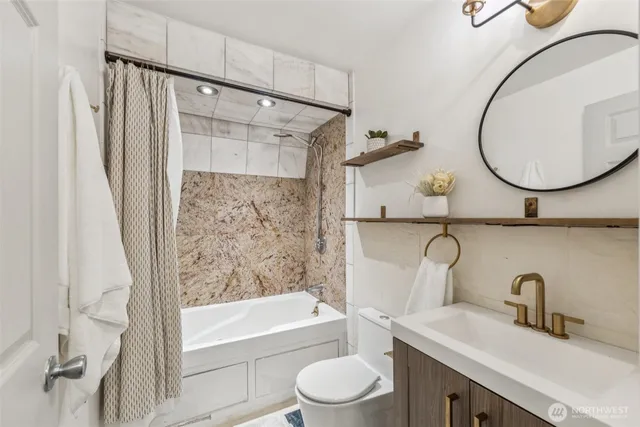 a bathroom with a sink a toilet and a mirror