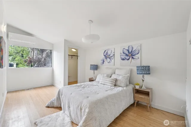 a bedroom with a large bed and a window