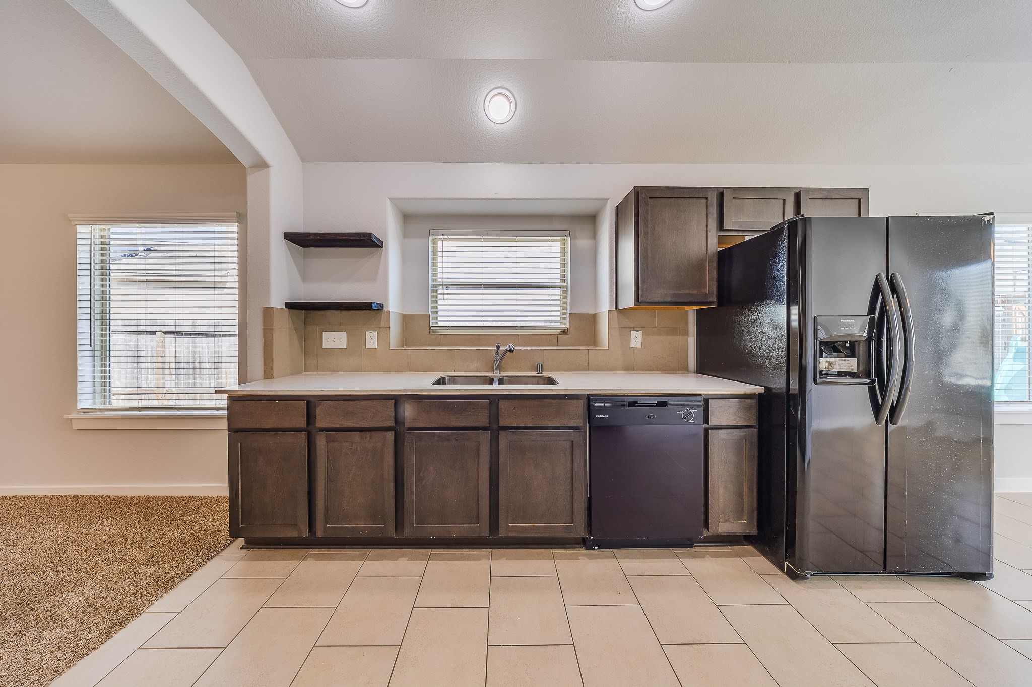 6807 Alamitos Court Rosharon, TX 77583 - Photo 12 of 34 Kitchen with warm wood-tone cabinetry, offering stylish storage, a welcoming atmosphere, and functional space for cooking and entertaining.