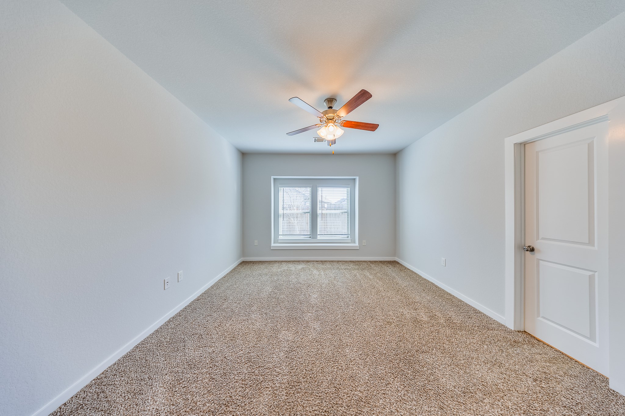 6807 Alamitos Court Rosharon, TX 77583 - Photo 23 of 34 Bedroom 2 filled with natural light from large windows, creating a bright, airy, and welcoming atmosphere.