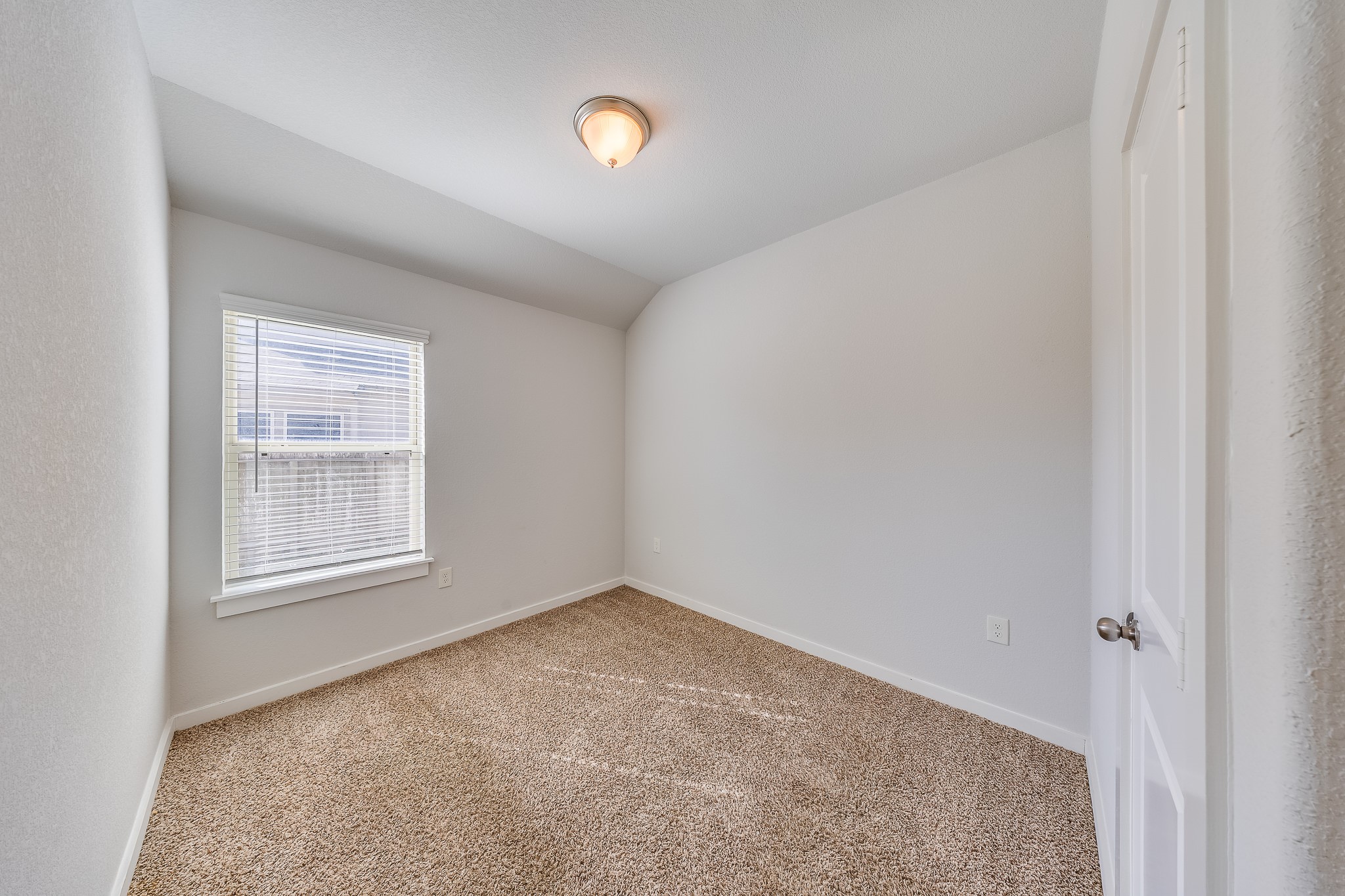 6807 Alamitos Court Rosharon, TX 77583 - Photo 27 of 34 Bedroom 2 filled with natural light from large windows, creating a bright, airy, and welcoming atmosphere.