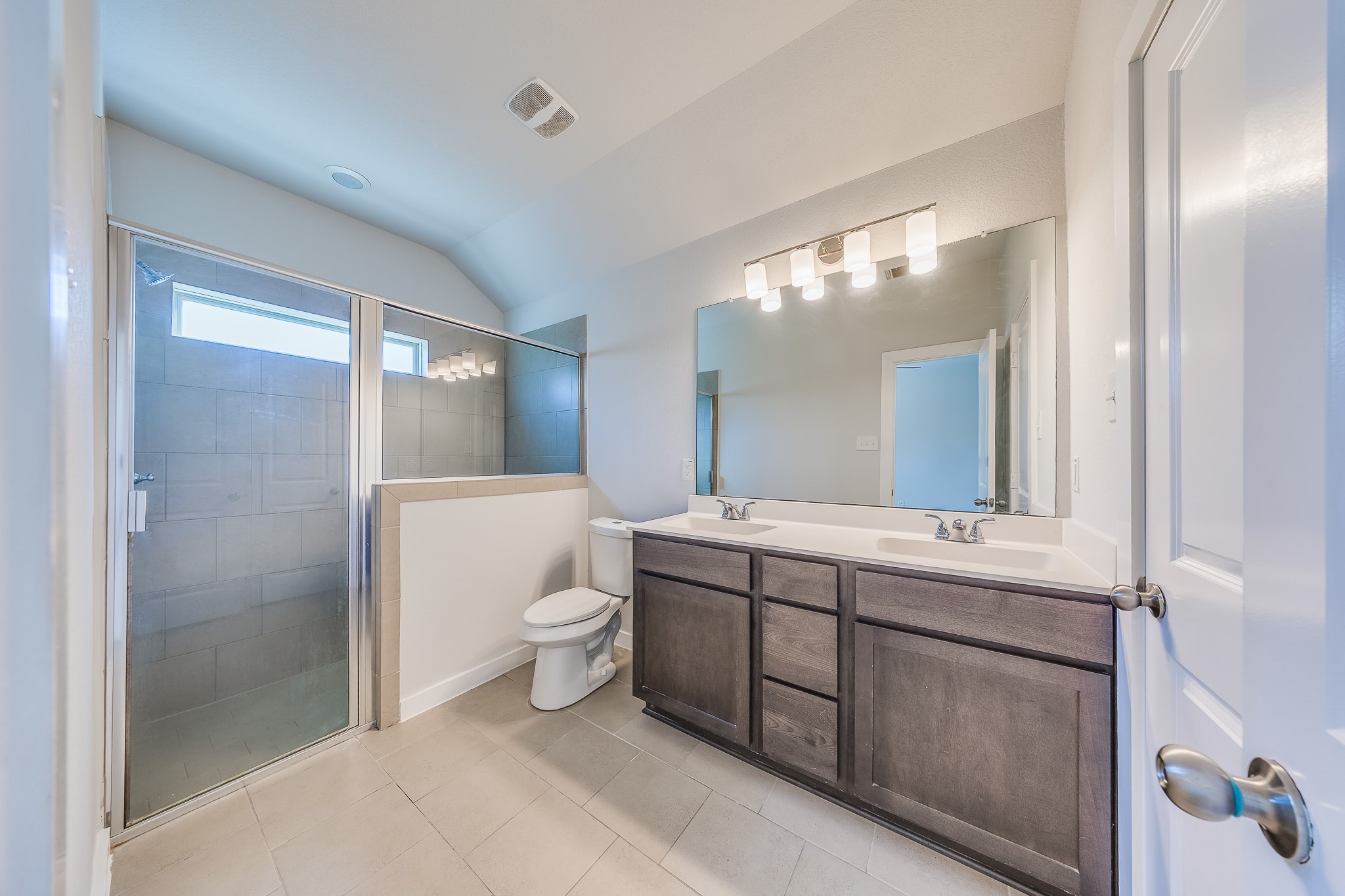 6807 Alamitos Court Rosharon, TX 77583 - Photo 5 of 34 Spacious primary bathroom offering dual vanities, elegant finishes, and a relaxing layout designed for comfort and daily convenience.