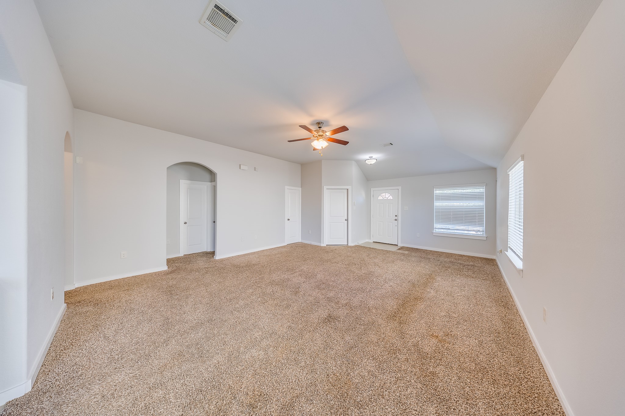 6807 Alamitos Court Rosharon, TX 77583 - Photo 10 of 34 Soft carpeted living room creating a warm, comfortable feel, perfect for cozy evenings and everyday family living.