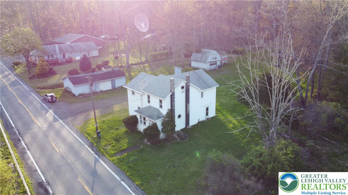 5444 Quakake Road Weatherly, PA 18255 - Photo 2 of 21 An aerial view captures a serene landscape with a classic residence and lush surroundings.