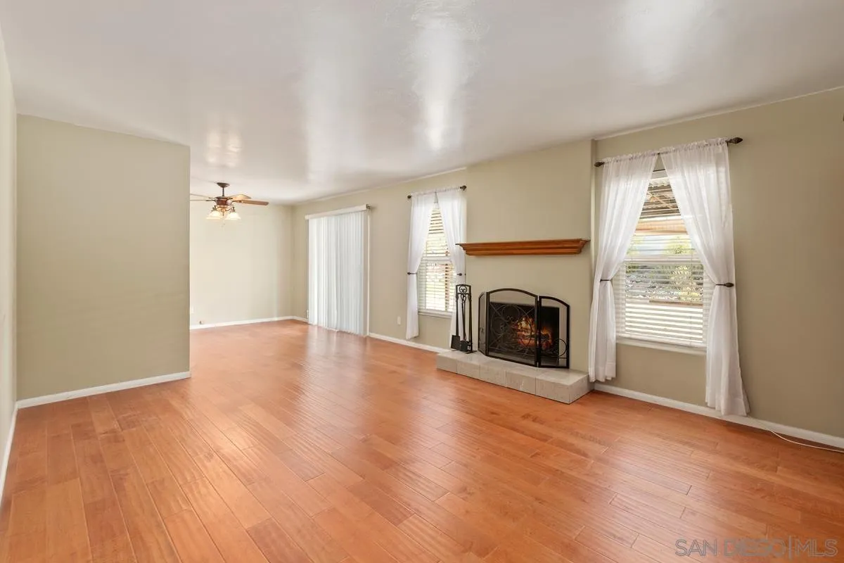9343 Oakbourne Road Santee, CA 92071 - Photo 2 of 19 a view of an empty room with a fireplace and a window
