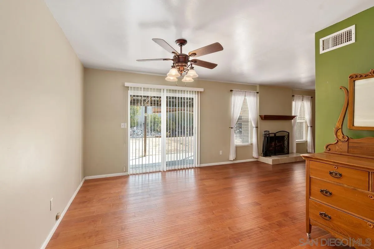 9343 Oakbourne Road Santee, CA 92071 - Photo 4 of 19 a view of an empty room with window and wooden floor
