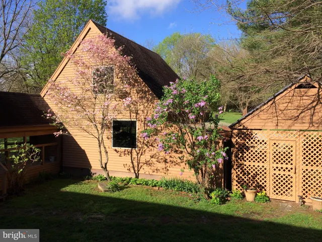 a kitchen with stainless steel appliances granite countertop a stove top oven a sink a dining table and chairs with wooden floor