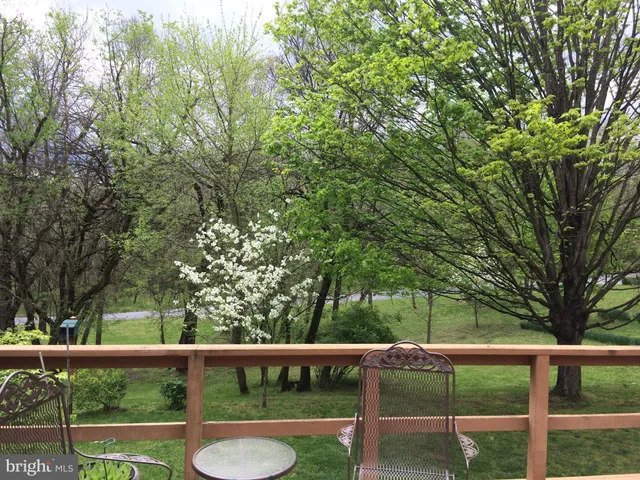 a close up of a sink and a yard in the back
