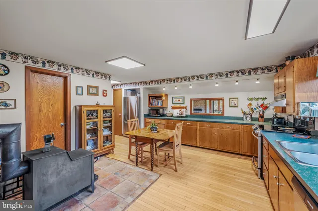 a patio with a table and chairs and potted plants