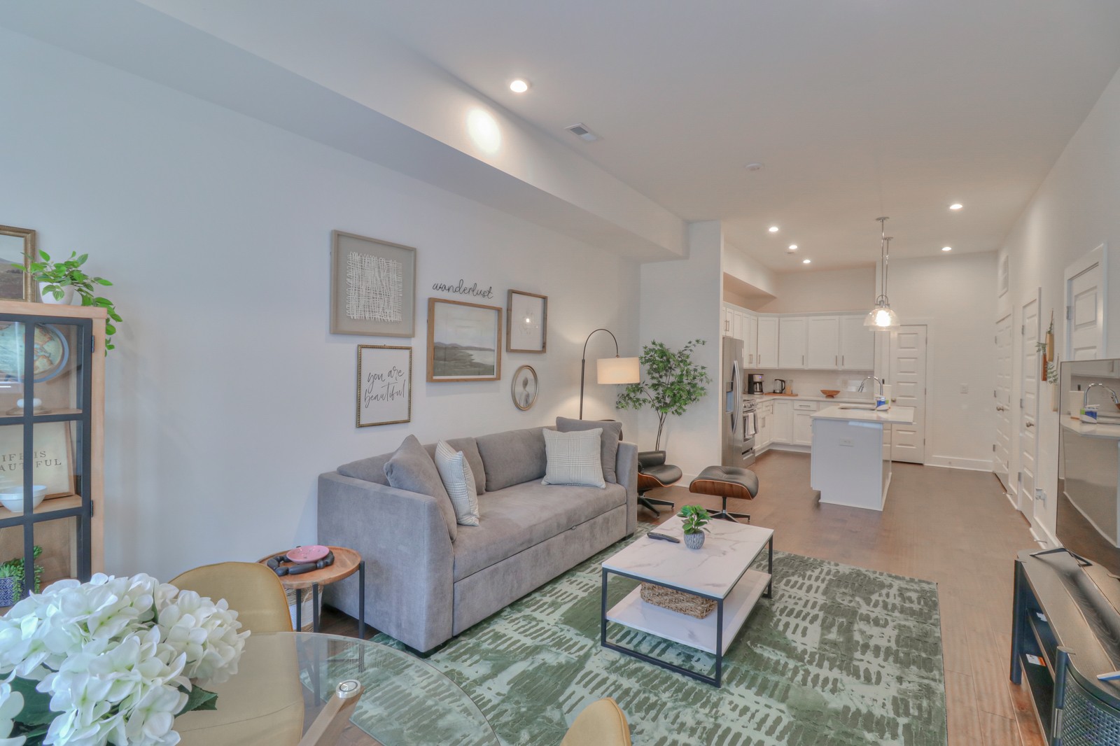 a living room with furniture and wooden floor