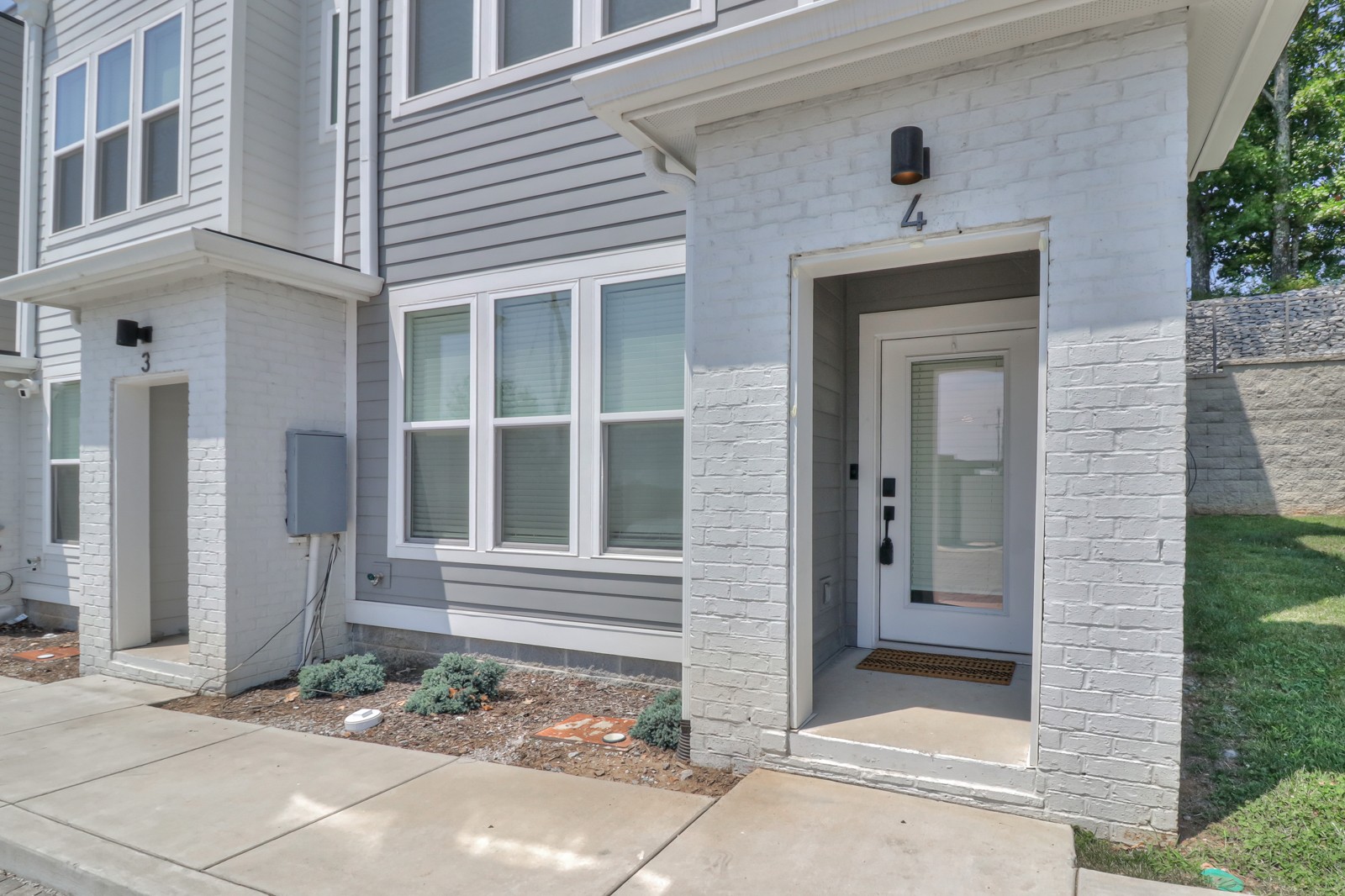 500 Creative Way, Unit 4 Madison, TN 37115 - Photo 36 of 38 a front view of a house with a yard and garage