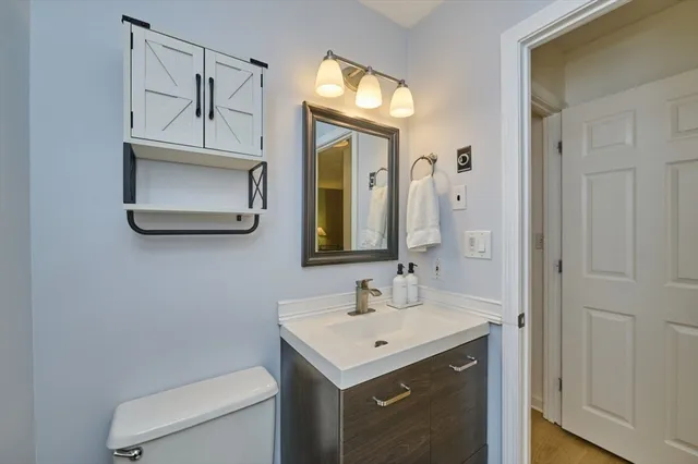 a bathroom with a toilet sink and mirror