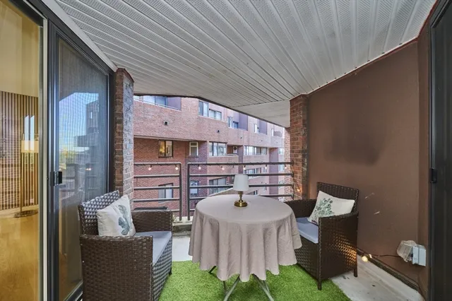 a balcony with furniture and a potted plant