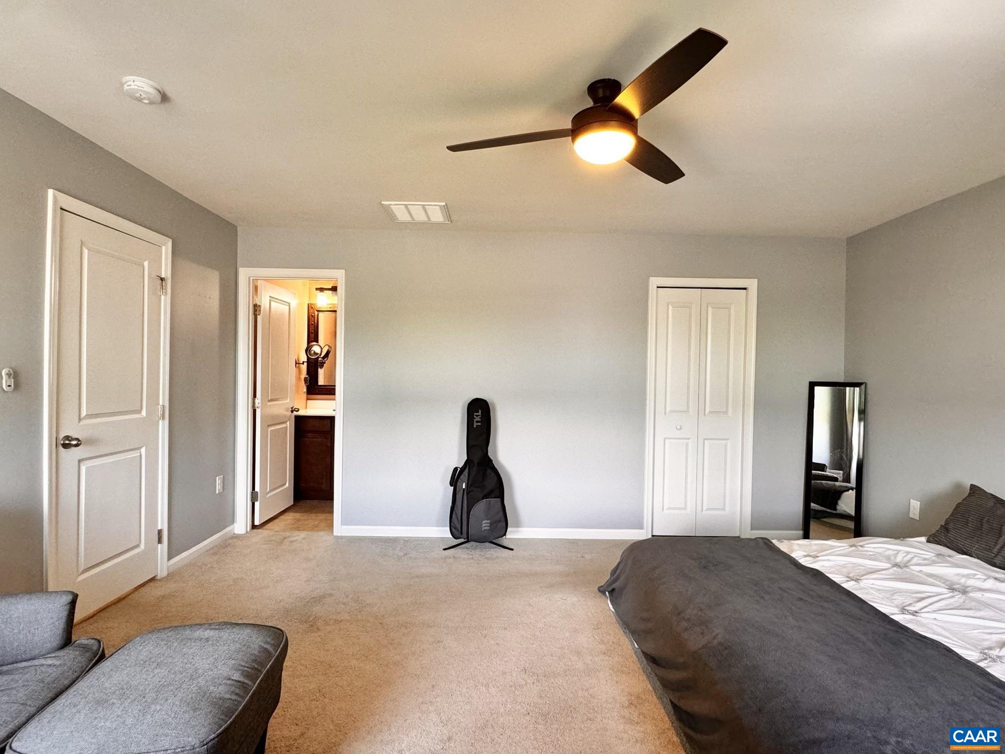 155 Richards Court Ruckersville, VA 22968 - Photo 11 of 51 a bedroom with a bed and a chandelier