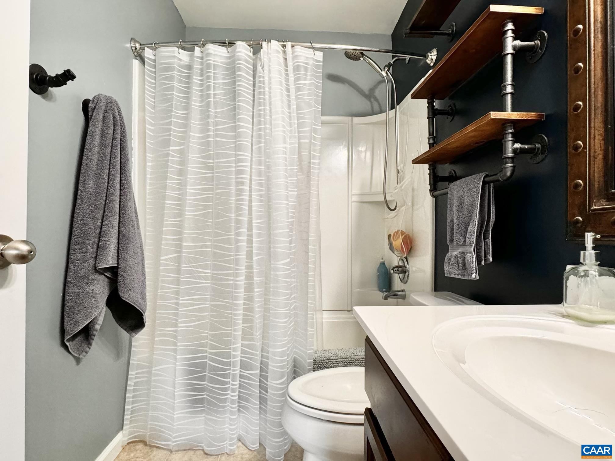 155 Richards Court Ruckersville, VA 22968 - Photo 14 of 51 a bathroom with a sink a toilet and shower curtain