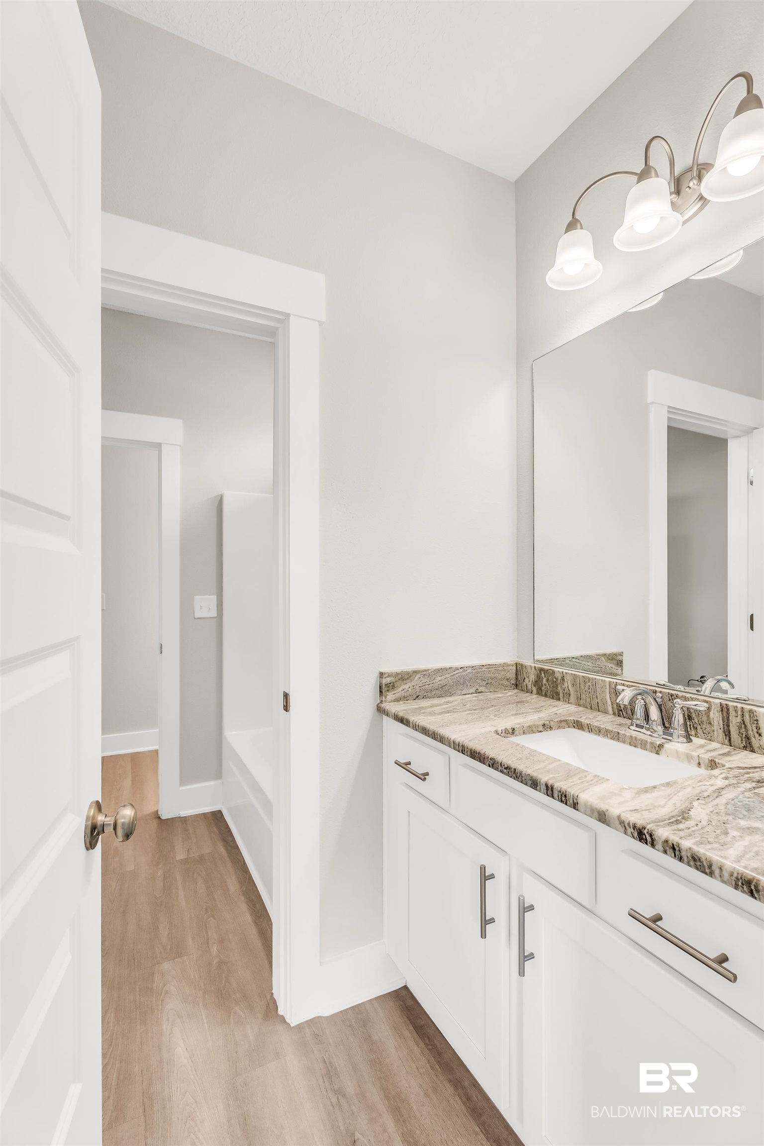 1720 Partridge Street Foley, AL 36535 - Photo 25 of 32 Bathroom featuring hardwood / wood-style floors and vanity