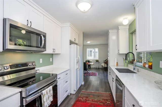 a kitchen with a sink stove and microwave
