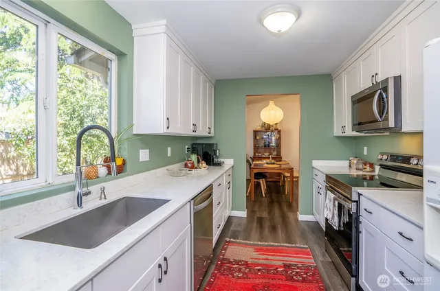 a kitchen with a sink stove and cabinets