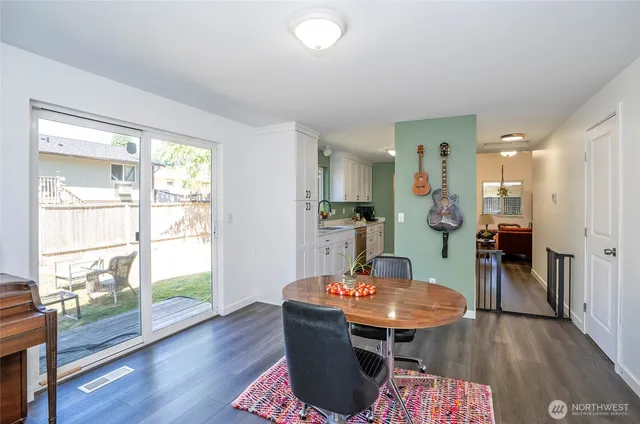 a dining room with furniture and wooden floor