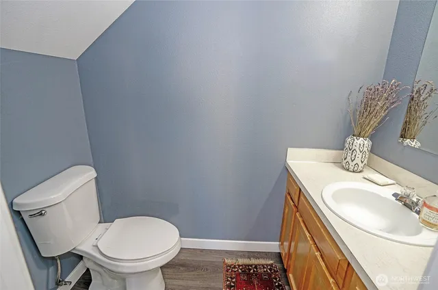 a bathroom with a sink toilet and mirror