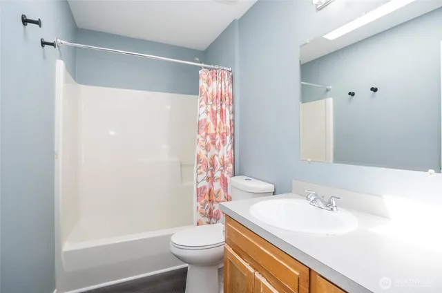 a view of a patio with table and chairs and potted plants with wooden fence