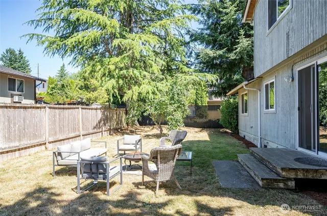 a view of backyard of house with outdoor seating