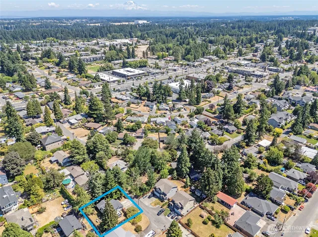 an aerial view of residential building with parking and yard