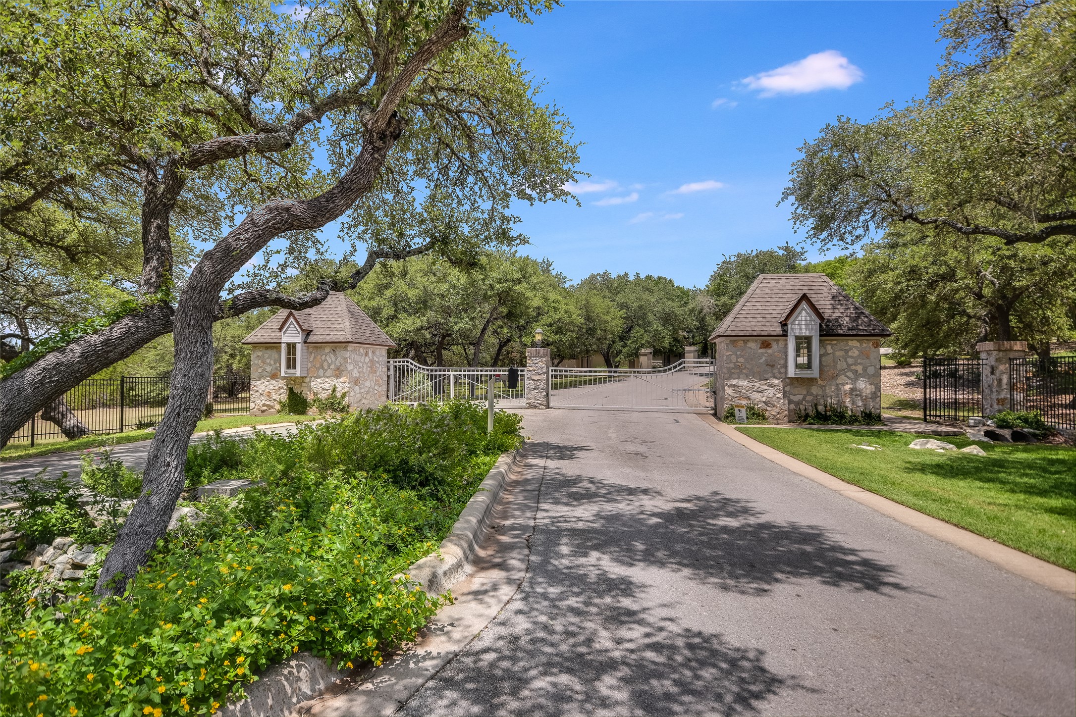 8611 Young Lane Austin, TX 78737 - Photo 1 of 40 a house with green field in front of it