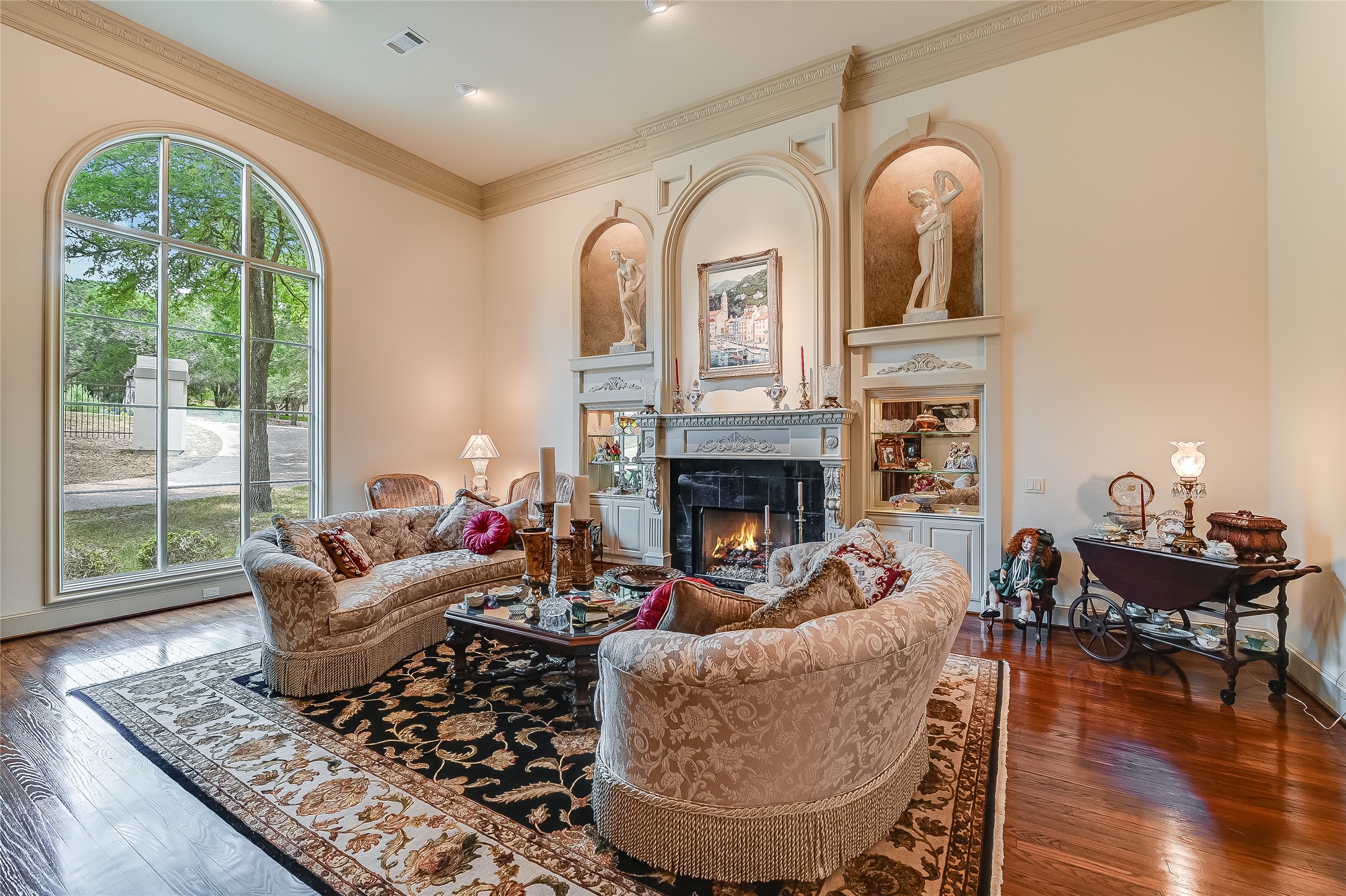 8611 Young Lane Austin, TX 78737 - Photo 11 of 40 a living room with furniture a fireplace and a floor to ceiling window