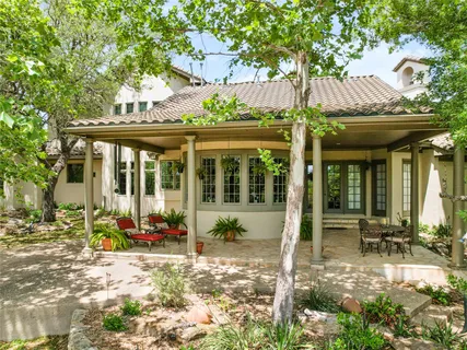 a patio with yard glass top table and chairs