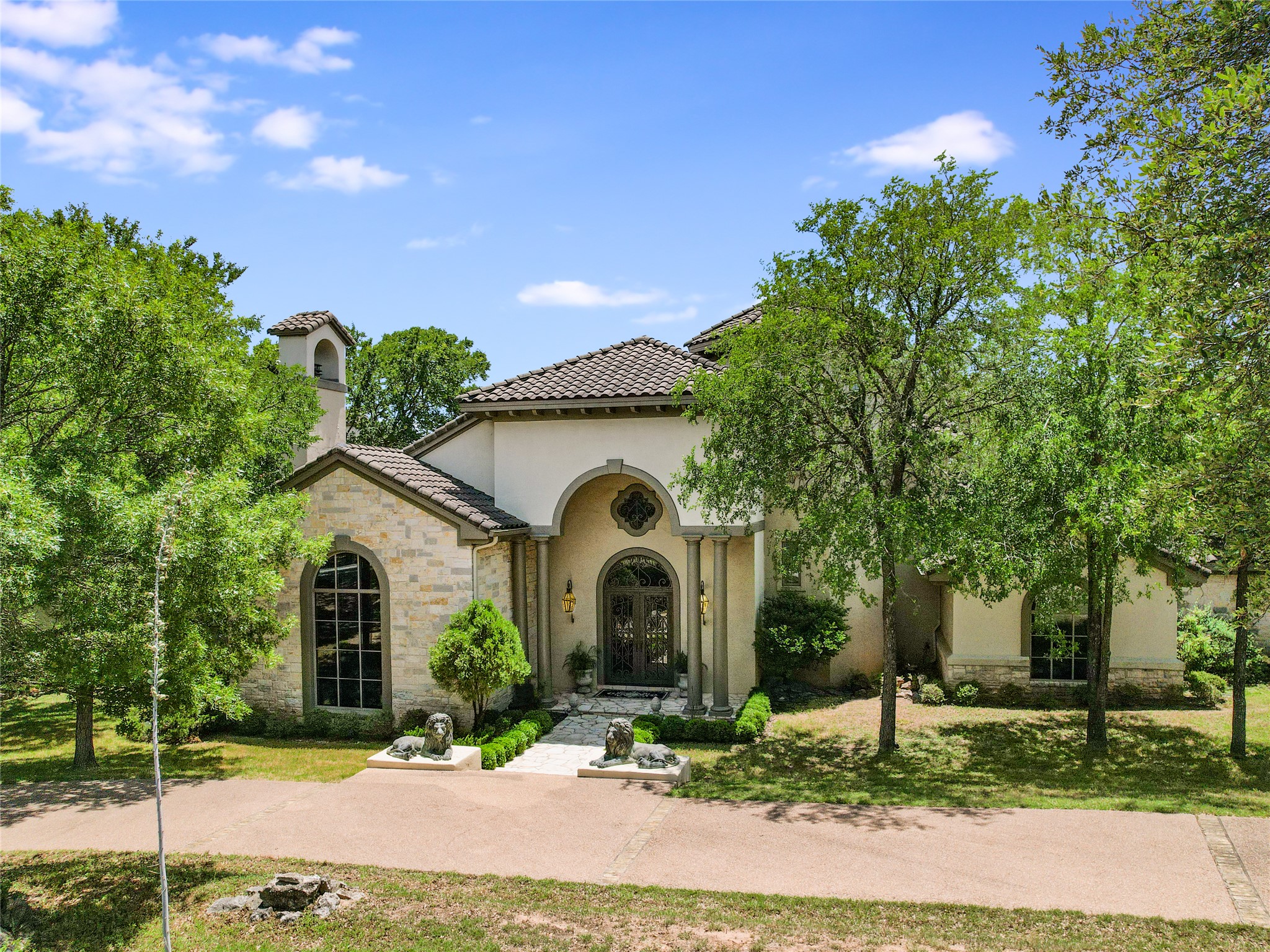 8611 Young Lane Austin, TX 78737 - Photo 35 of 40 a front view of a house with garden
