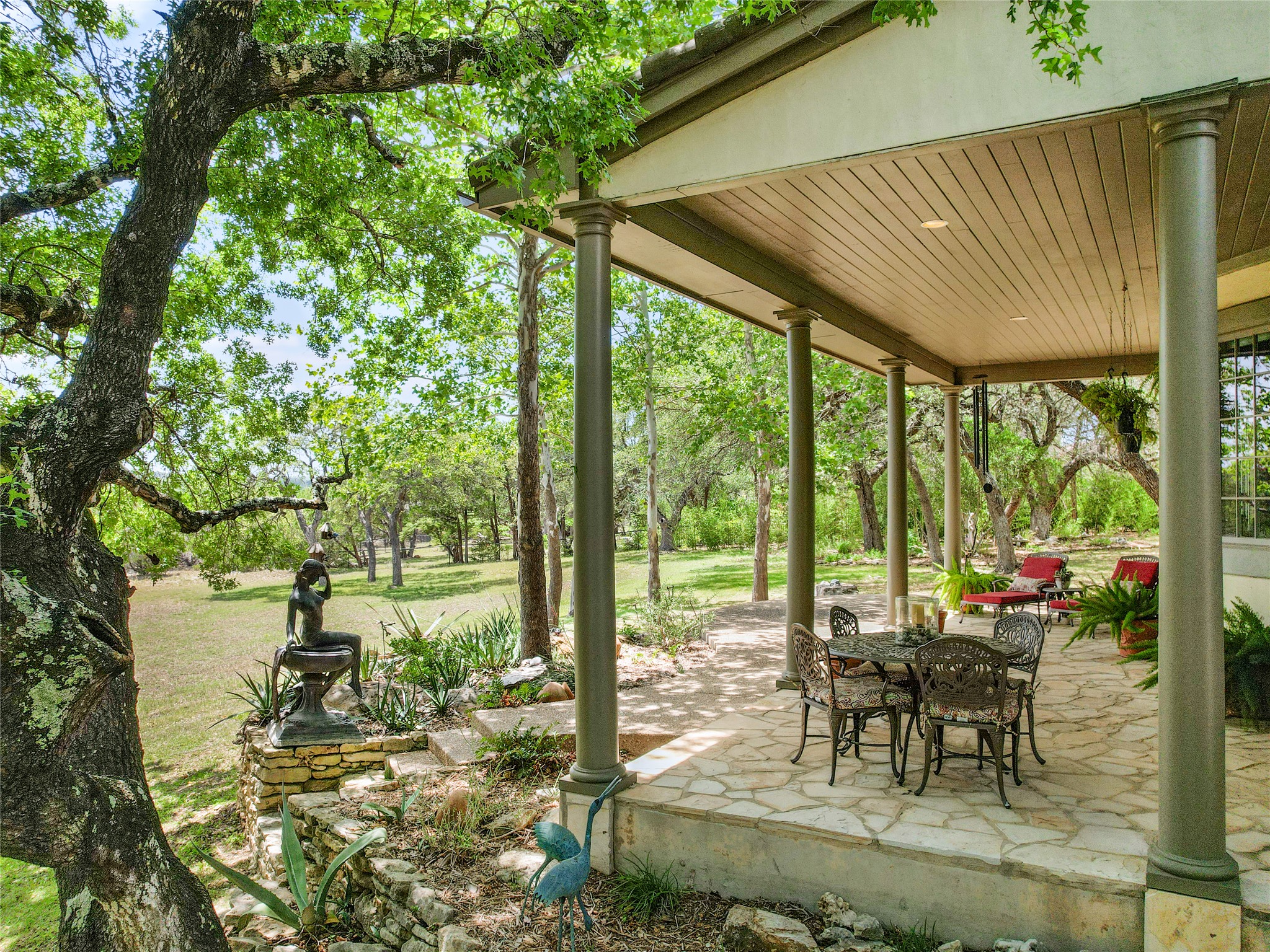 8611 Young Lane Austin, TX 78737 - Photo 36 of 40 a patio with yard glass top table and chairs