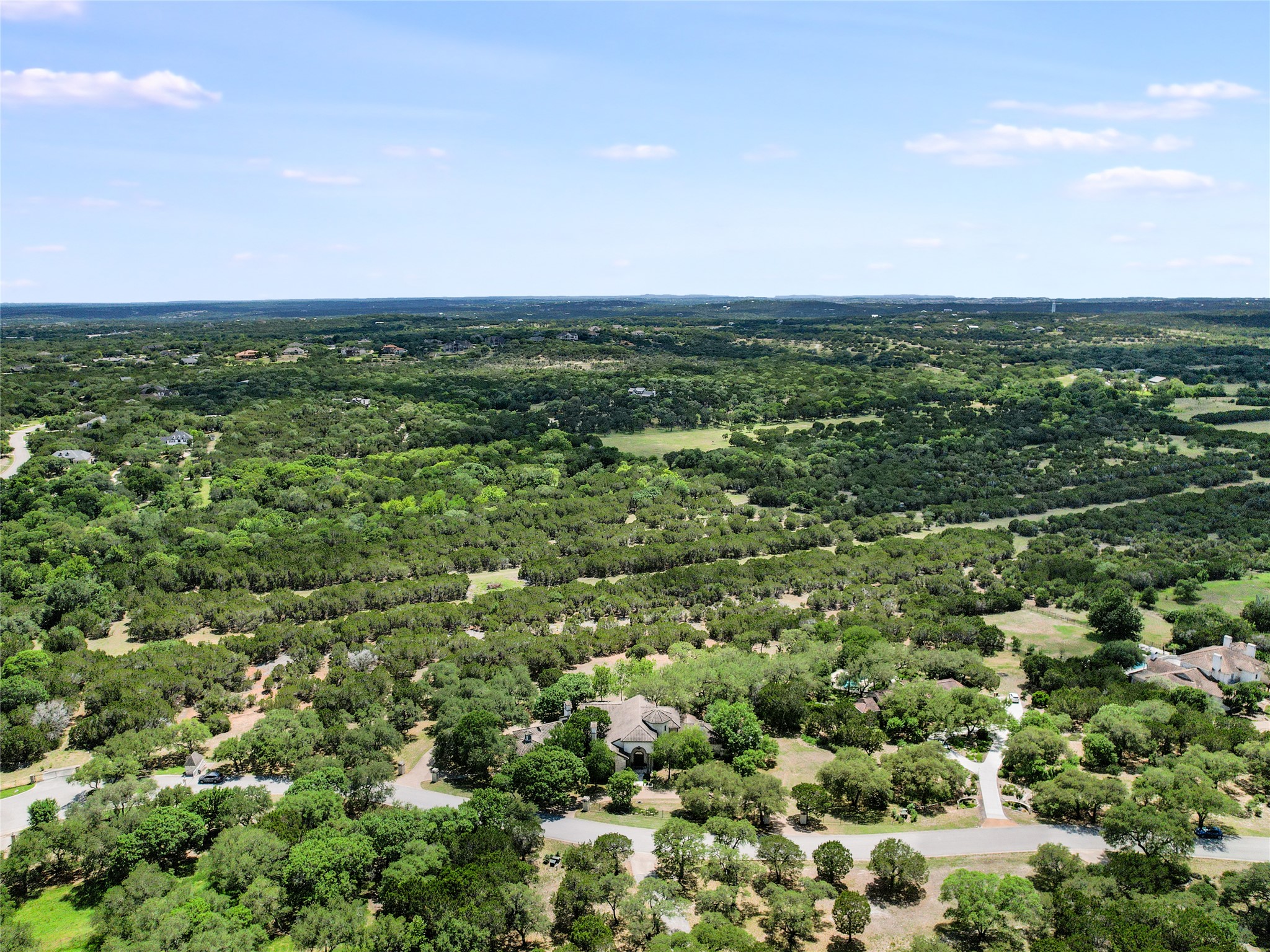 8611 Young Lane Austin, TX 78737 - Photo 39 of 40 an aerial view of residential houses with outdoor space and trees