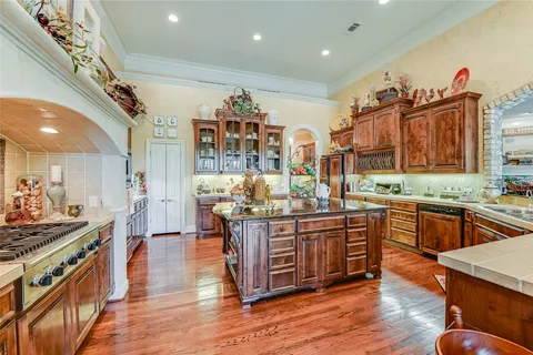 a open kitchen with stainless steel appliances granite countertop a sink and a refrigerator