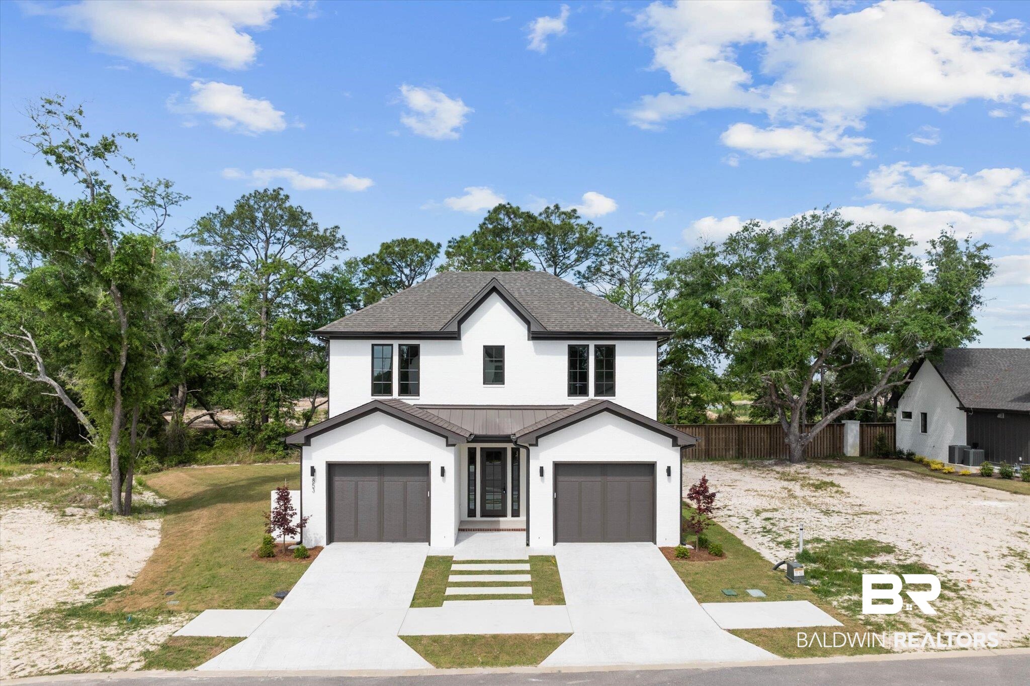 853 Inlet Circle Gulf Shores, AL 36542 - Photo 43 of 55 Modern farmhouse with metal roof, central AC, fence, concrete driveway, and stucco siding