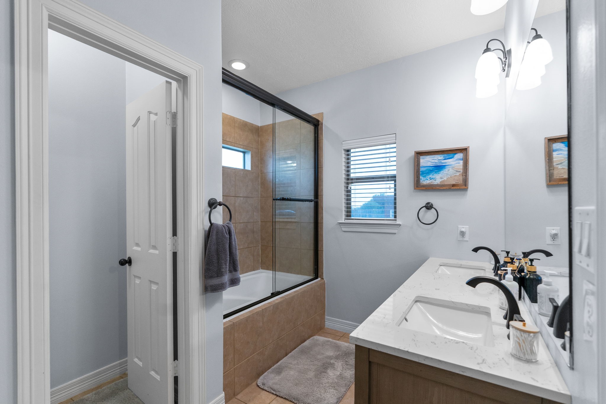 5942 Wildflower Road Sealy, TX 77474 - Photo 16 of 41 a bathroom with a sink and a large mirror