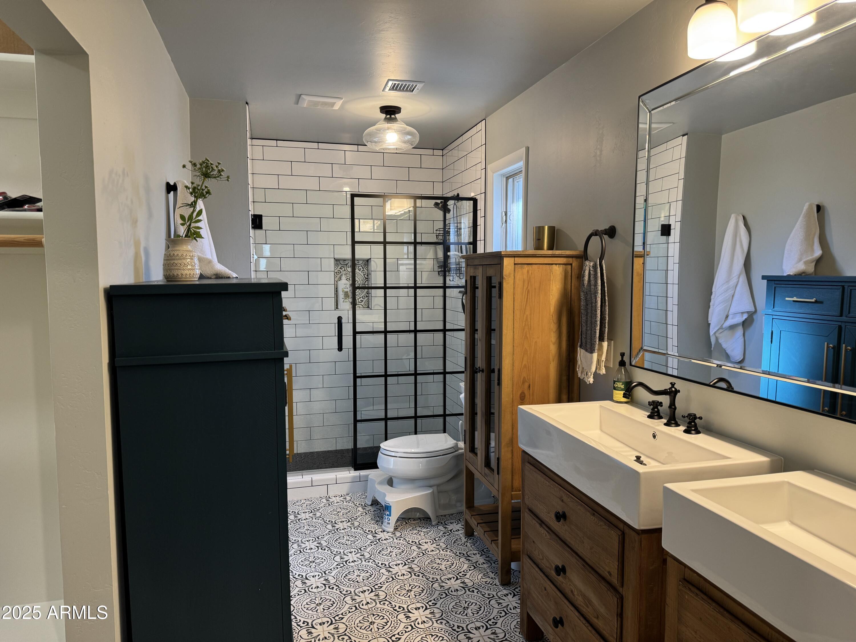 1675 East Appalachian Road Flagstaff, AZ 86004 - Photo 14 of 26 a bathroom with a sink toilet and shower