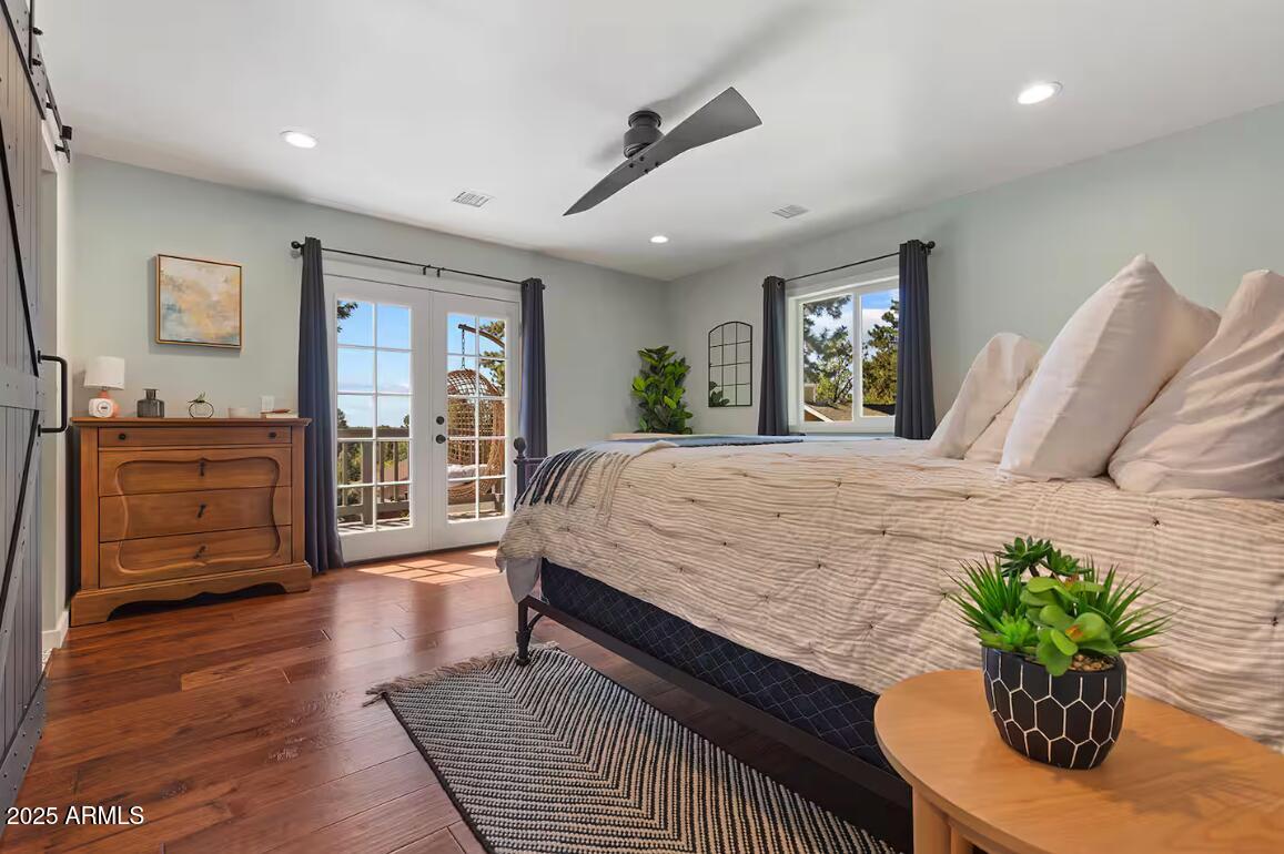 1675 East Appalachian Road Flagstaff, AZ 86004 - Photo 15 of 26 a bedroom with a large bed and wooden floor