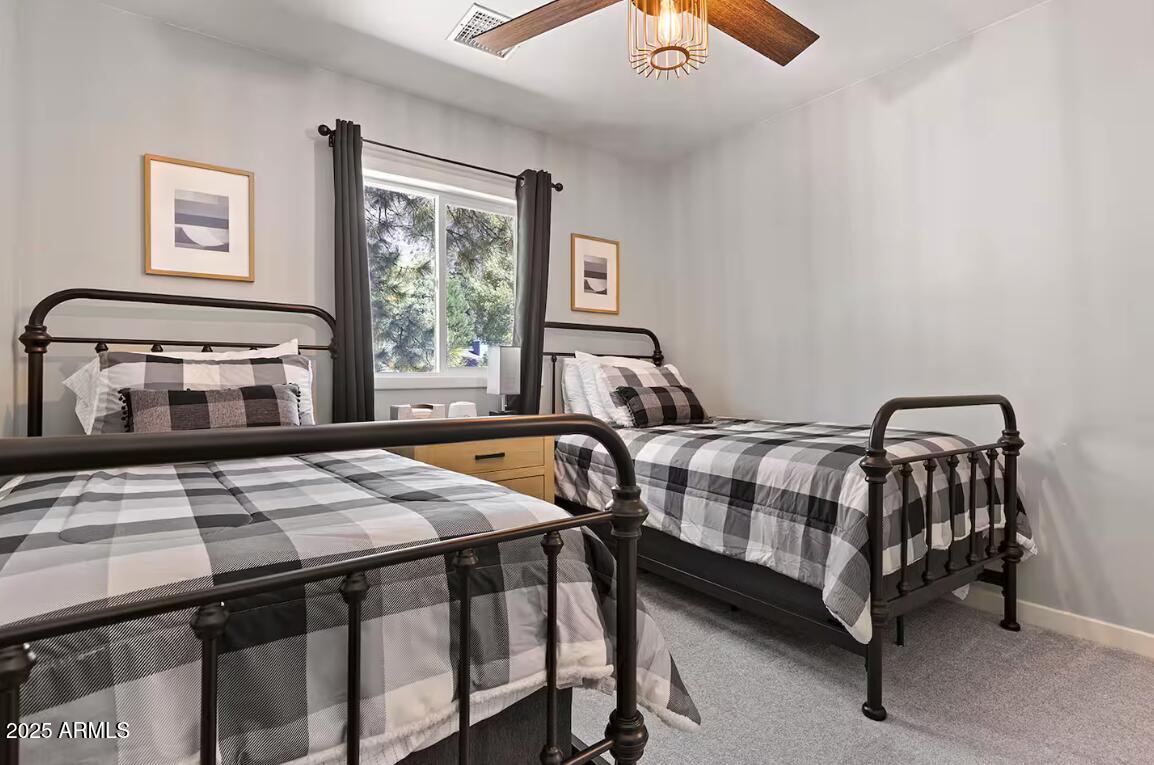 1675 East Appalachian Road Flagstaff, AZ 86004 - Photo 16 of 26 a bedroom with a bed a window and dresser