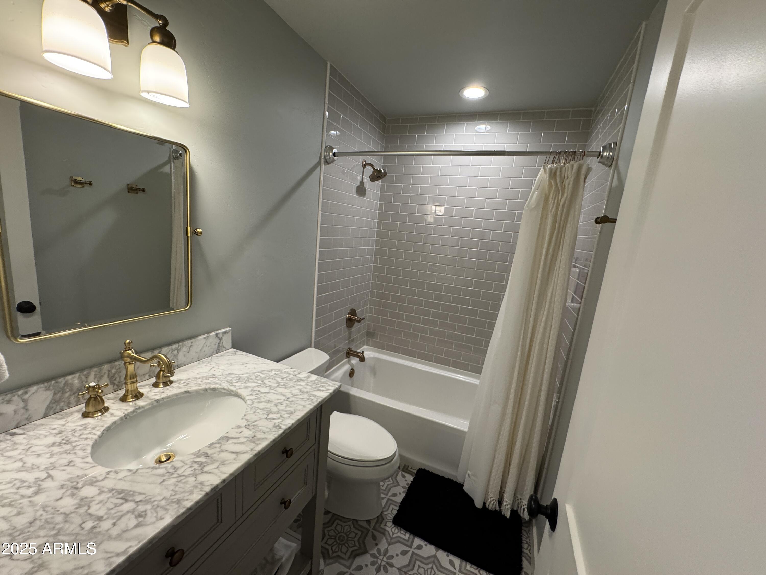 1675 East Appalachian Road Flagstaff, AZ 86004 - Photo 17 of 26 a bathroom with a granite countertop sink toilet and shower