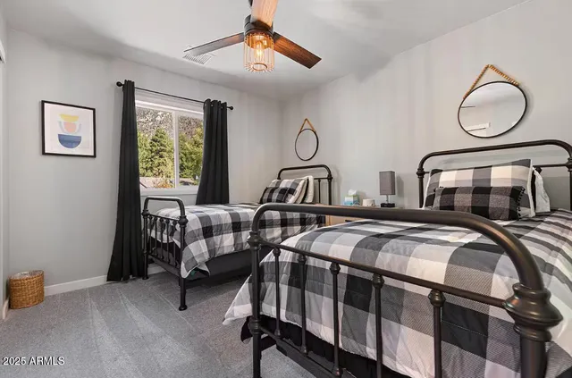 a bedroom with two beds and a window