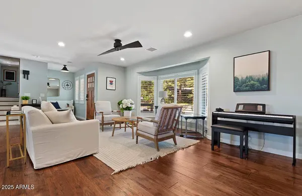 a living room with furniture and a wooden floor