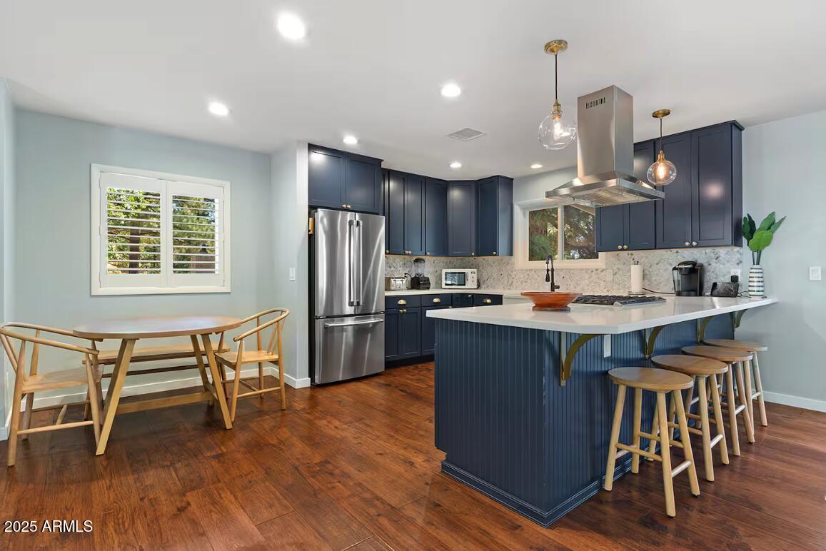 1675 East Appalachian Road Flagstaff, AZ 86004 - Photo 9 of 26 a kitchen with a table chairs refrigerator and microwave