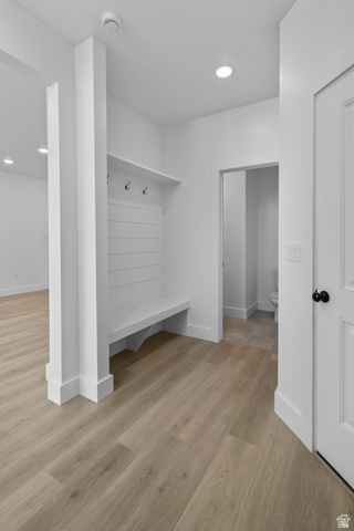 248 West 2920th Street South Logan, UT 84321 - Photo 23 of 47 Built-in mudroom bench with coat hooks, wood-finish flooring, recessed lighting, and white paneled door with matte black hardware