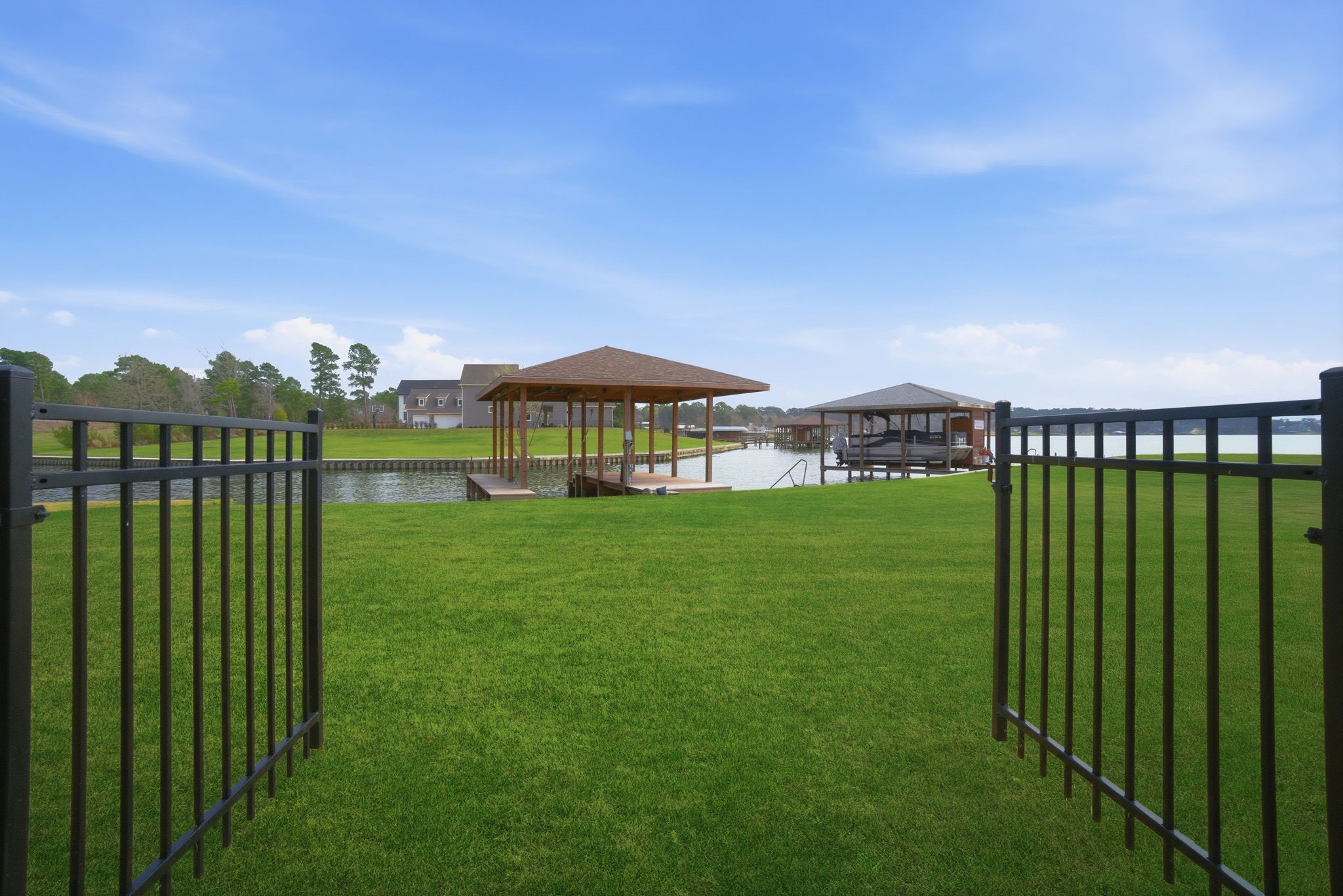 255 Peninsula Drive Livingston, TX 77351 - Photo 2 of 50 Fenced back yard with double gates leading out to the boathouse.