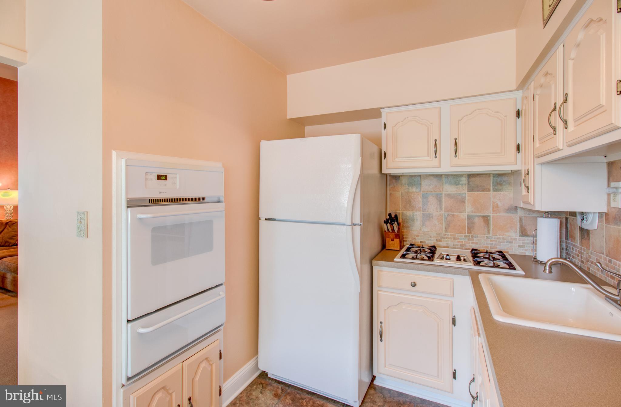 30 Dover Road Hamilton, NJ 08620 - Photo 13 of 32 a white refrigerator freezer and a stove sitting inside of a kitchen