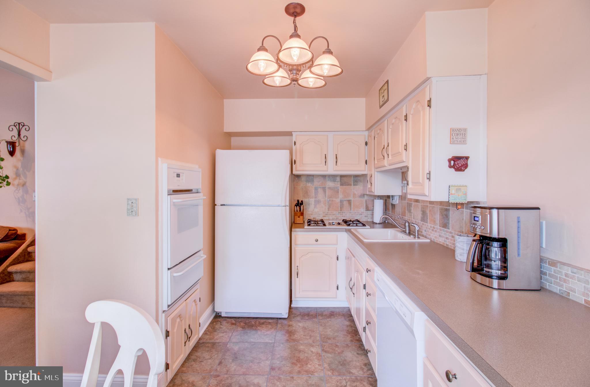 30 Dover Road Hamilton, NJ 08620 - Photo 15 of 32 a kitchen with refrigerator cabinets and a center island