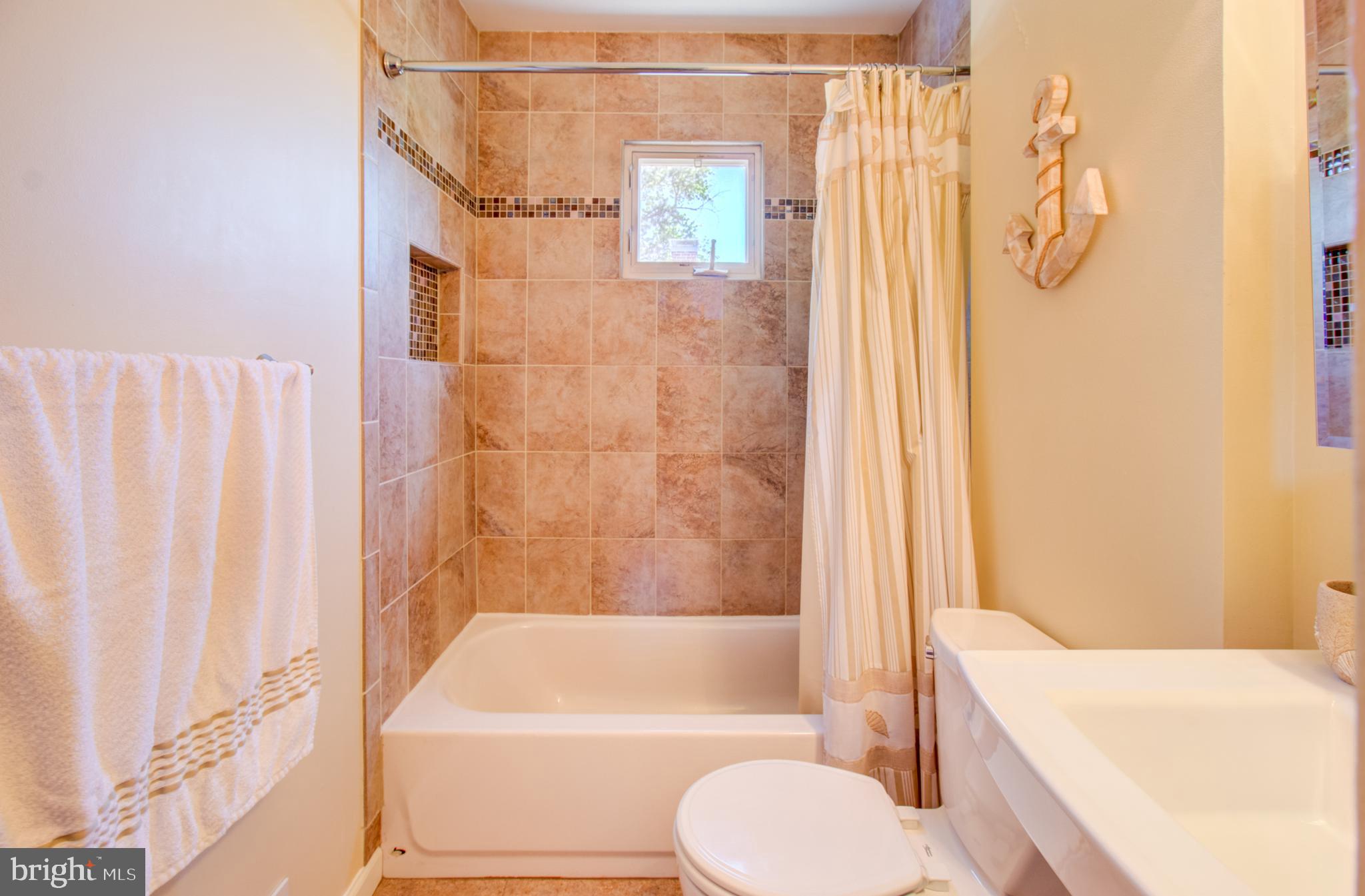 30 Dover Road Hamilton, NJ 08620 - Photo 23 of 32 a bathroom with a shower curtain and a bathtub