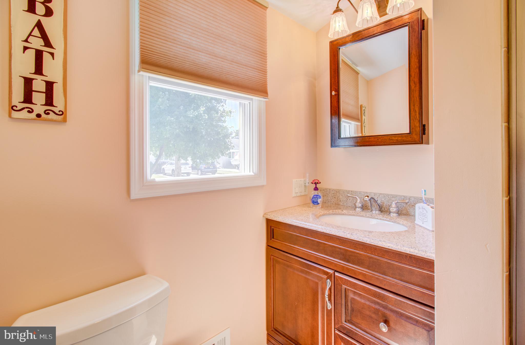 30 Dover Road Hamilton, NJ 08620 - Photo 24 of 32 a bathroom with a sink a mirror and a toilet